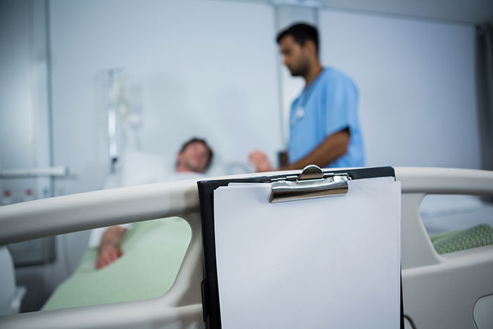 clipboard hanging on bed in hospital